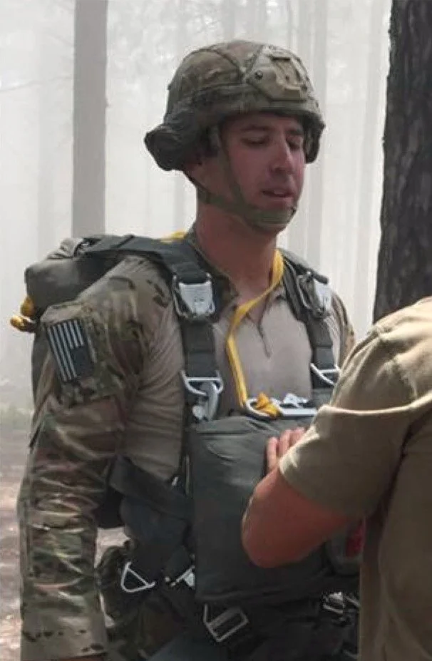 Ryan Adams in Army uniform wearing parachute equipment